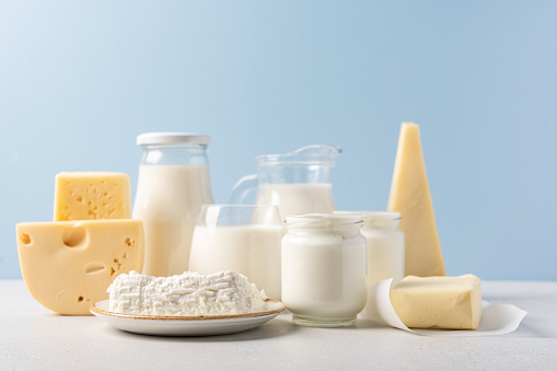 Jug of milk, cheese, butter, yogurt or sour cream, cottage cheese. Farm dairy products concept