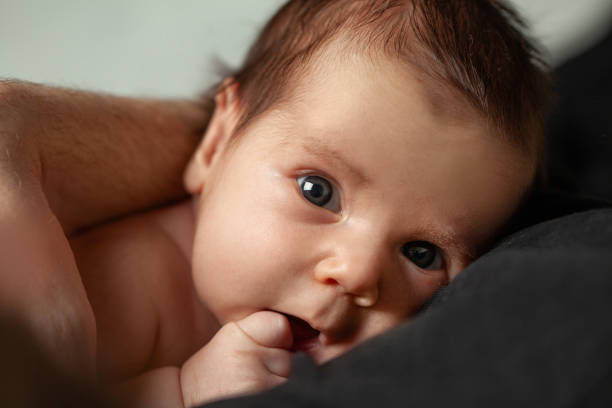 istock Cheerful newborn baby in parents hands 1417355285