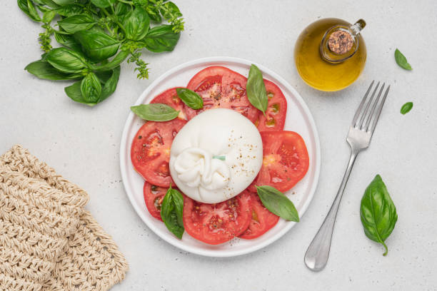 istock Tomato salad with buratta cheese or mozzarella and basil. 1417355494