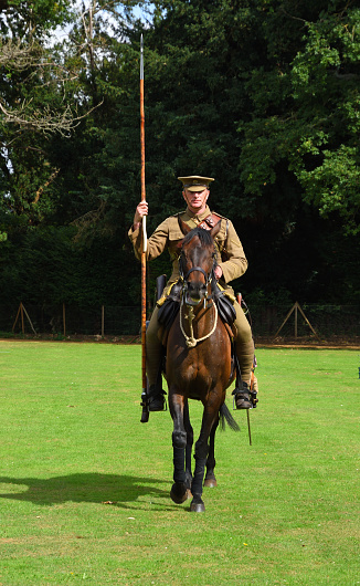 Silsoe, Bedfordshire, England - August 14, 2021: World War One Lancer mounted and in Uniform isolated in park land.