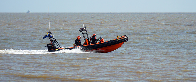 Felixstowe, Suffolk, England - April 30, 2022:  Inshore Rescue Boat with crew on patrol at Felixstowe.