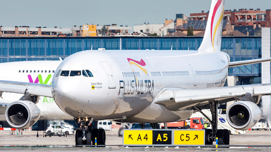 Madrid, Spain 26 March 2018. Airbus A340 of Plus Ultra airline taxiing at Madrid - Barajas airport on a sunny summer day.