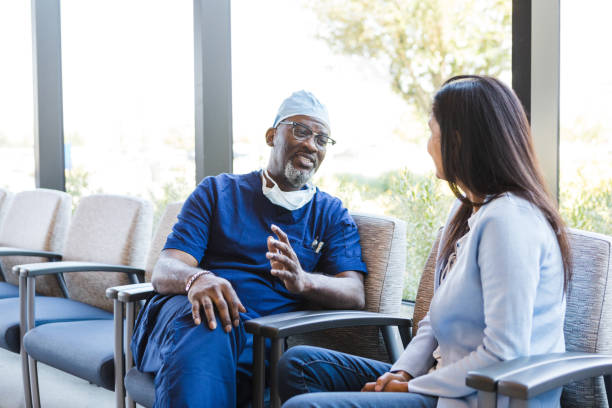istock Surgeon gestures while talking to his female patient 1417359339
