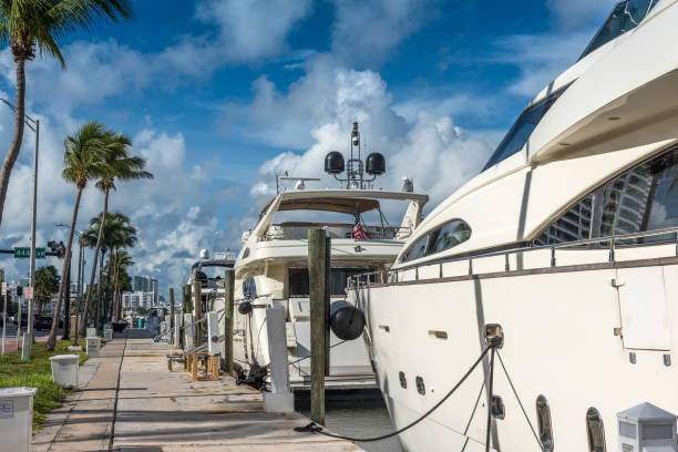 Miami, Florida, USA - August 22, 2022: Luxury boats by Miami Beach marina beside Fontainebleau Hotel on a sunny morning.