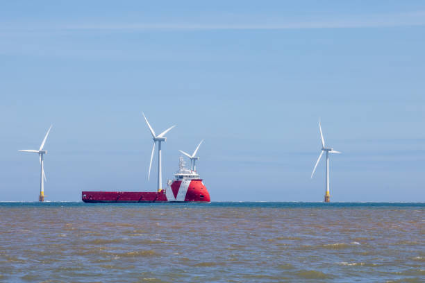 istock Offshore wind farm turbines with maintenance with supply ship 1417377588