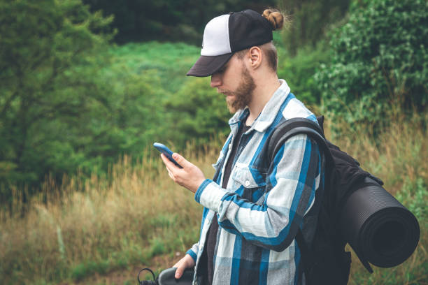 istock A male traveler with a backpack looks into a smartphone. 1417377782