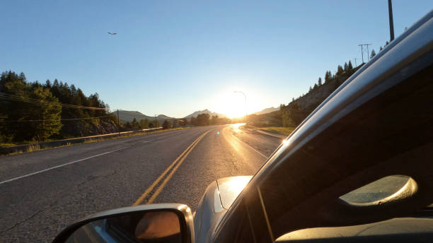 istock POV from vehicle down road at sunrise 1417377979