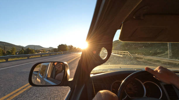 istock POV from vehicle down road at sunrise 1417378113