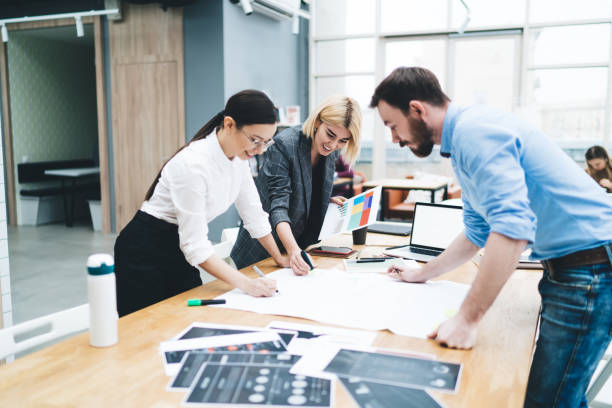 istock Coworkers writing and drawing on paper 1417378796