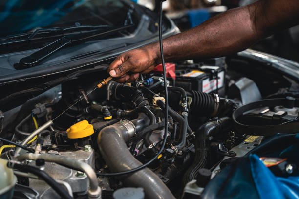 istock Mechanic pulling out the dipstick to check the engine oil level. 1417382253