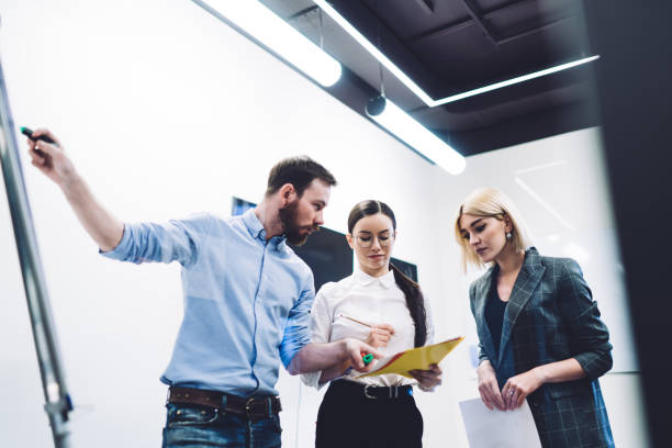 istock Work group of business people doing research with white board at office 1417387696