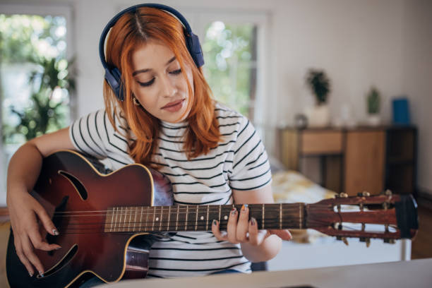 istock Woman playing guitar 1417390302