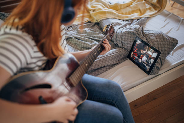 istock Woman having guitar lessons online 1417390462