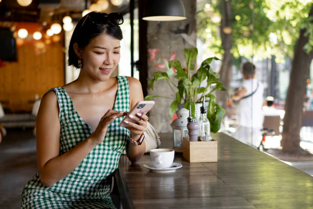 istock Sitting in a restaurant and using a smart phone 1417391532