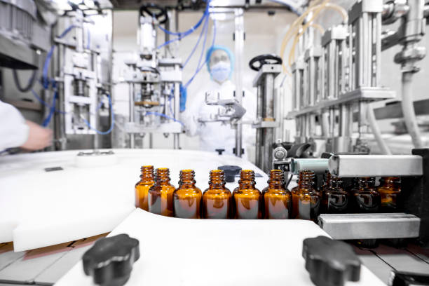 Pharmaceutical bottles seen arranged properly during the manufacturing in a pharmaceutical industry Small brown bottles seen perfectly arranged in a laboratory after production and all the proper checks during manufacturing in a pharmaceutical factory. pharmaceutical factory stock pictures, royalty-free photos & images