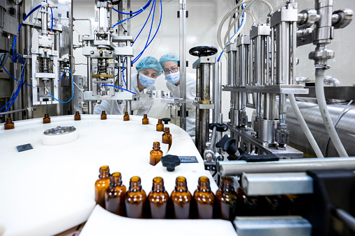 Small brown bottles seen perfectly arranged in a laboratory after production and all the proper checks during manufacturing in a pharmaceutical factory.