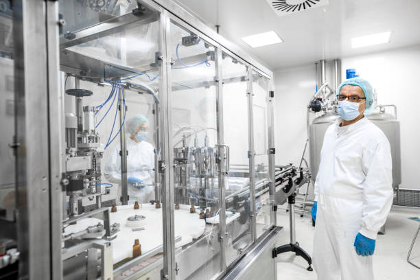 istock Two fully equipped coworkers in protective workwear seen in a pharmaceutical laboratory 1417393034