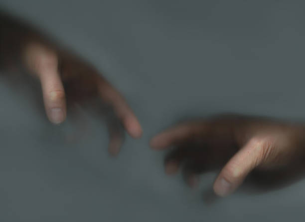 istock Two hands reaching out to each other in the mist 1417394434