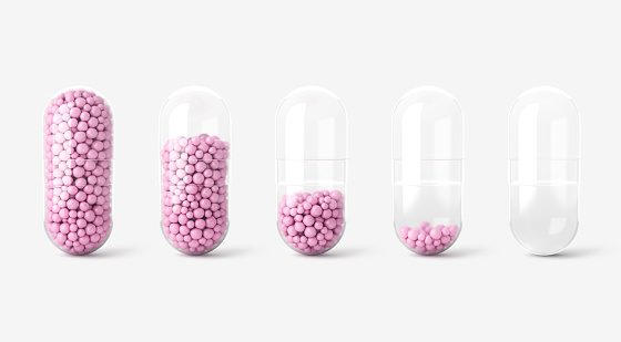 Close up of transparent and pink pills medicine on light background. Medical metaphor, revealing the concept of care and beauty. 3d render