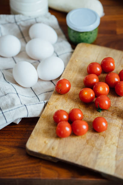 istock Ingredients for cooking: milk, eggs, tomatoes, on a white towel. 1417395587