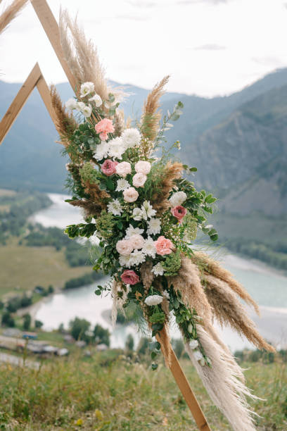 istock Wedding arch in the shape of a triangle with flowers 1417395764