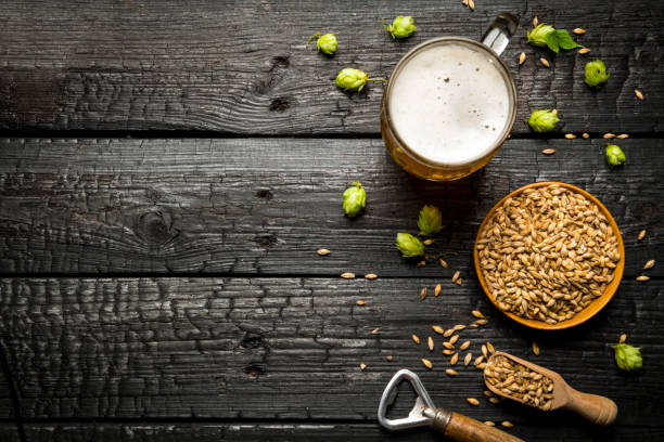 istock Mug of light beer with foam on a wooden table 1417396263