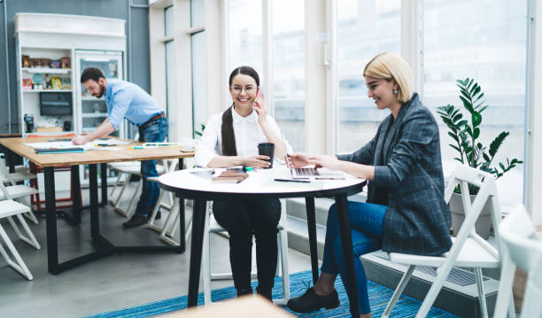 istock Concentrated man and smiling women in modern office 1417397835