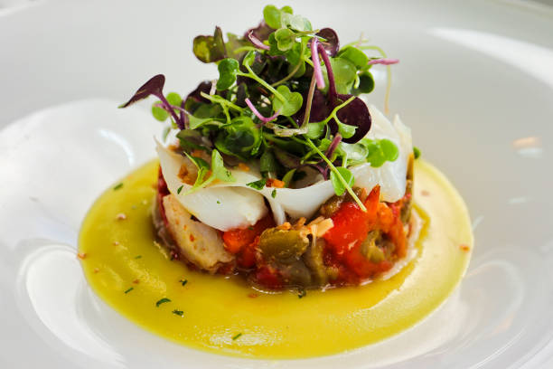 Cod timbale with micro mezclum mix sakura, roasted peppers and pil pil in Ortuella, Basque Country, Spain