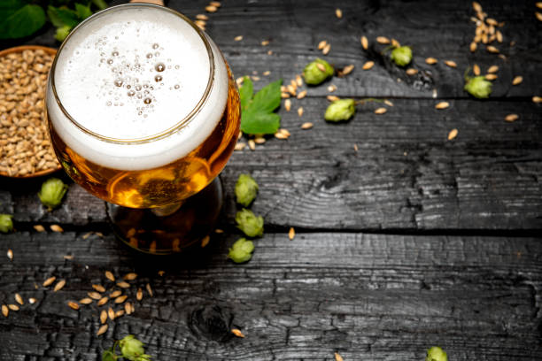 istock Mug of light beer with foam on a wooden table 1417398622