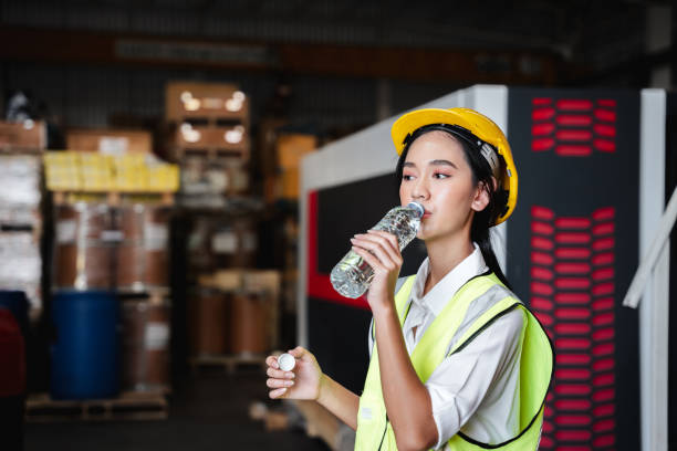istock Warehouse workers relax and drink water from bottles in warehouse. 1417398702
