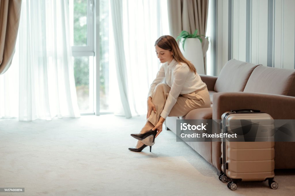 Businesswoman Taking Off Her Shoes Stock Photo - Download Image Now ...