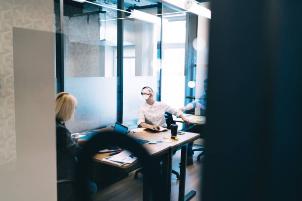 istock Cheerful employees talking in office 1417402817