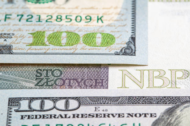 istock 100 US  dollar and 100 polish zloty banknotes 1417402958