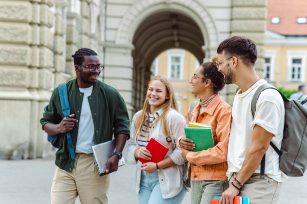 istock Multi-ethnic group of students talking in front of University 1417403292