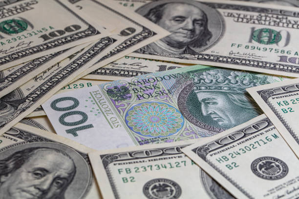 istock 100 US  dollar and 100 polish zloty banknotes 1417403475