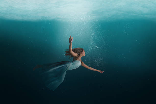 istock Girl floating underwater in a surreal dreamlike state 1417405367