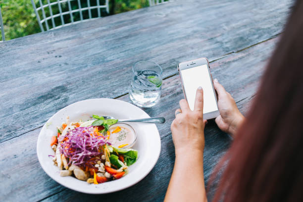 istock Unrecognizable woman messaging during meal 1417406779