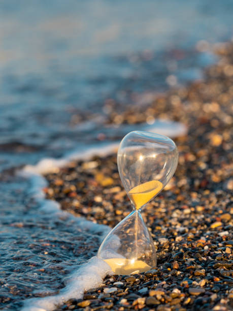istock Hourglass on the beach at the seashore 1417409144