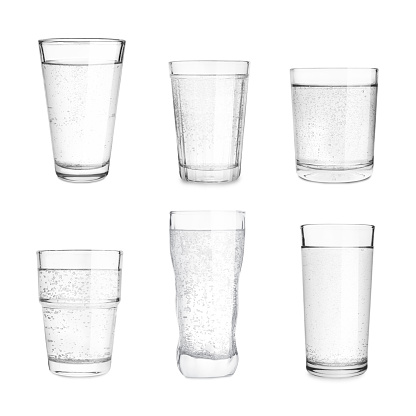 Set with different glasses of soda water on white background