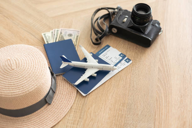 istock Flat lay composition with passport, toy plane and camera on wooden background, space for text. Visa receiving 1417410514