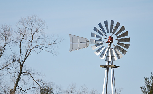 A wind pump rises from a green field in Door County near Forestville, Wisconsin.