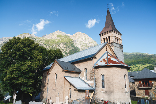 Church of Ornon village. This image was taken during a sunny summer day in Ornon small village streets in Oisans massif, Alps mountains, in Isere, Auvergne-Rhone-Alpes region in France.