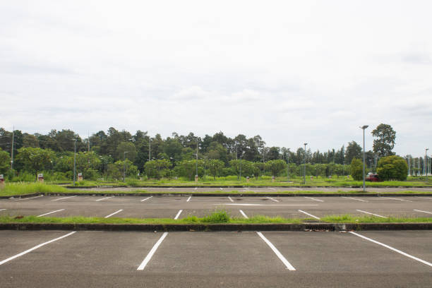 istock Empty parking lot on a green public square against an overcast background. 1417416535