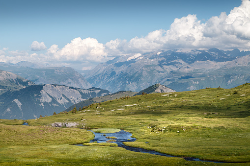 Beautiful panorama over the Ecrins national park. This image was taken during a sunny summer day near Ornon small village in Oisans massif, Alps mountains, in Isere, Auvergne-Rhone-Alpes region in France.