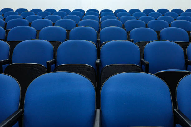 istock Rows of several blue chairs in an auditorium 1417417978