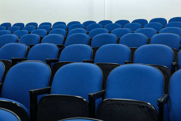 istock Rows of several blue chairs in an auditorium 1417417979