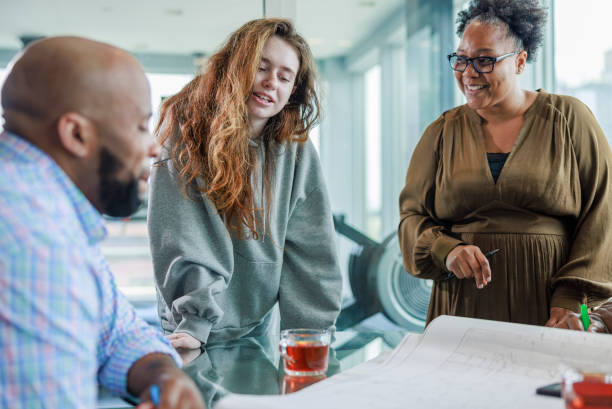 istock Multi-racial working partners brainstorming ideas for the project in the office. 1417418688