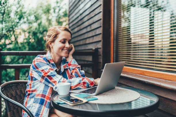 istock Woman at the terrace working during her summer vacation 1417420193