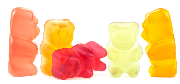 Funny colored gummy bears isolated on a white background. Fruit gum candies.