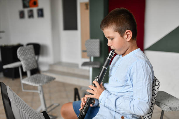 istock Small Boy Ready To Play New Piece On Clarinet 1417422103